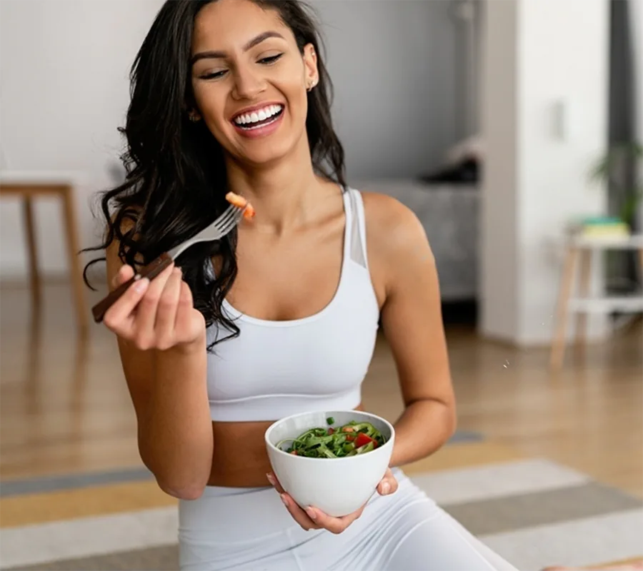 Happy fit woman having fun with persa's dietitian and nutritionist services where she used her workout machines